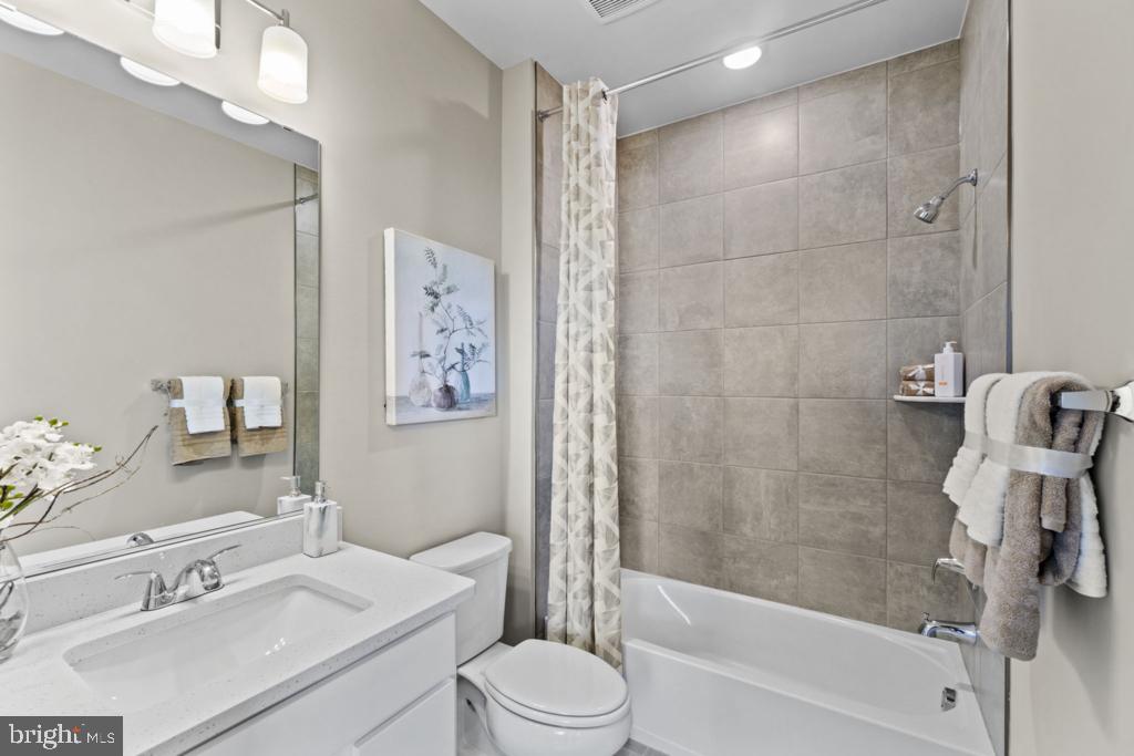 12535 Terrabrooke Avenue Brandywine, MD 20613 - Photo 22 of 32 a bathroom with a bathtub shower sink vanity mirror and toilet