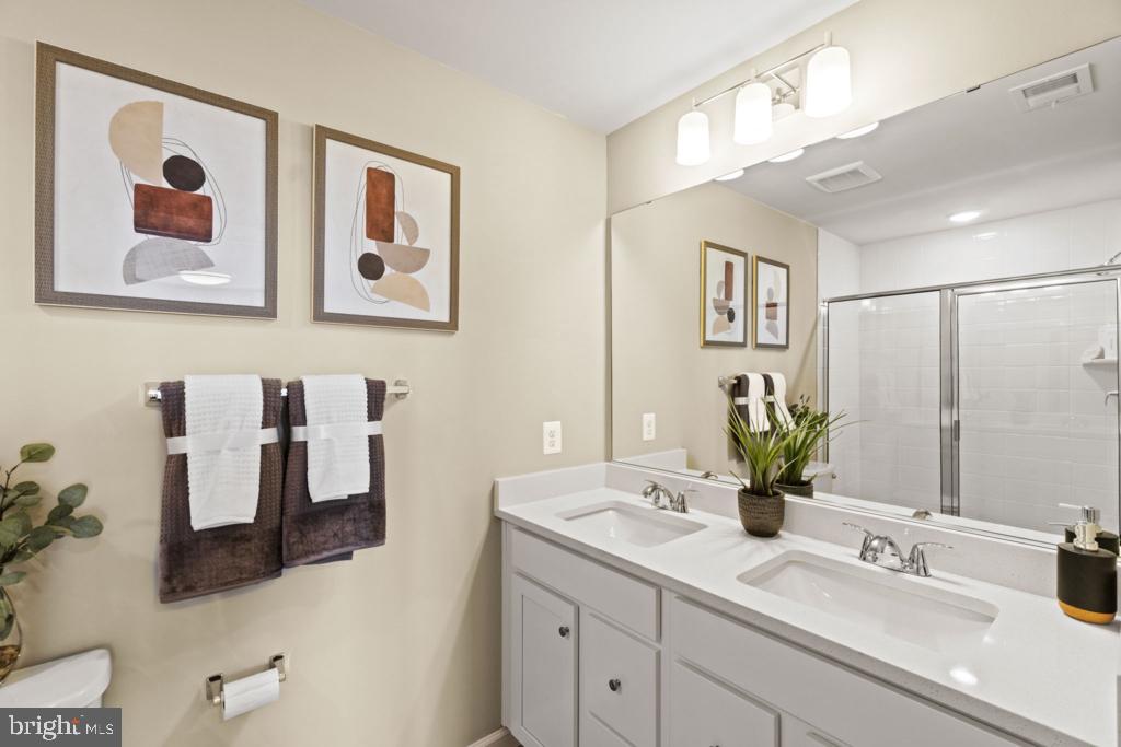 12535 Terrabrooke Avenue Brandywine, MD 20613 - Photo 27 of 32 a bathroom with a sink mirror and vanity