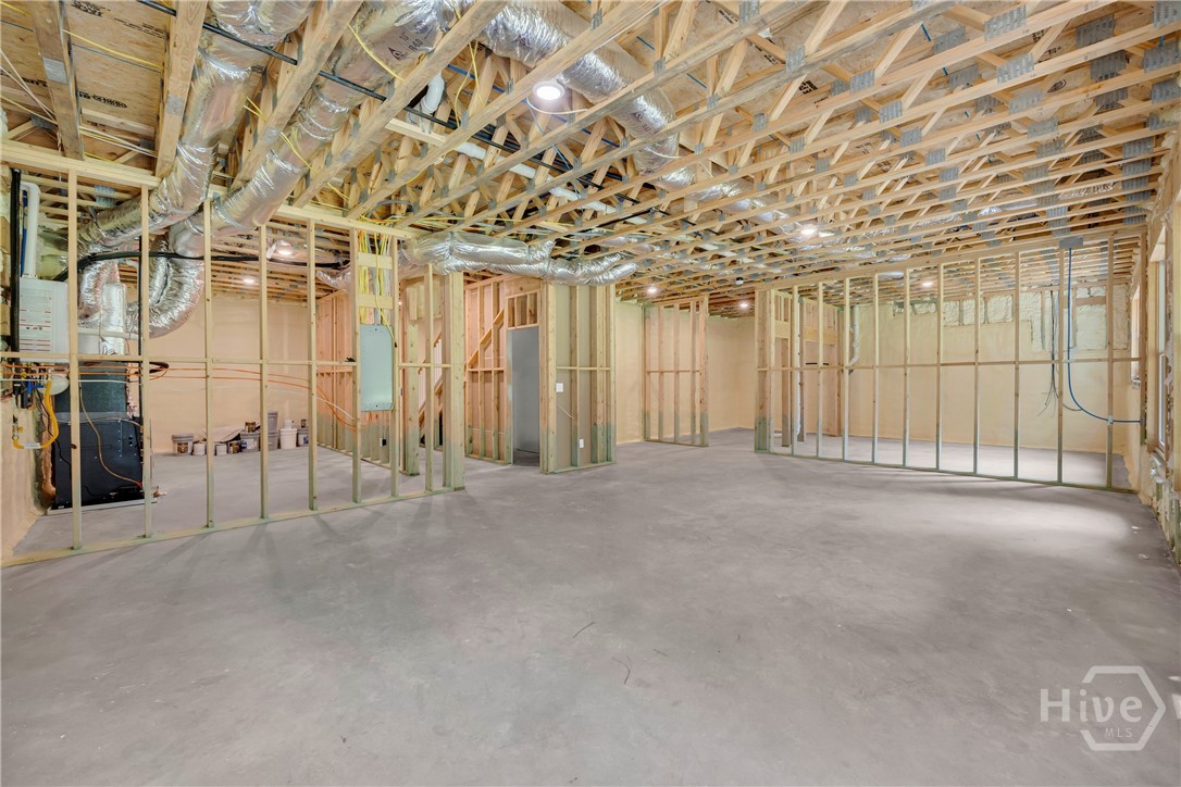 2476 St Martin Way Monroe, GA 30656 - Photo 70 of 75 Unfinished basement space featuring exposed wood framing, concrete flooring, and recessed ceiling lighting