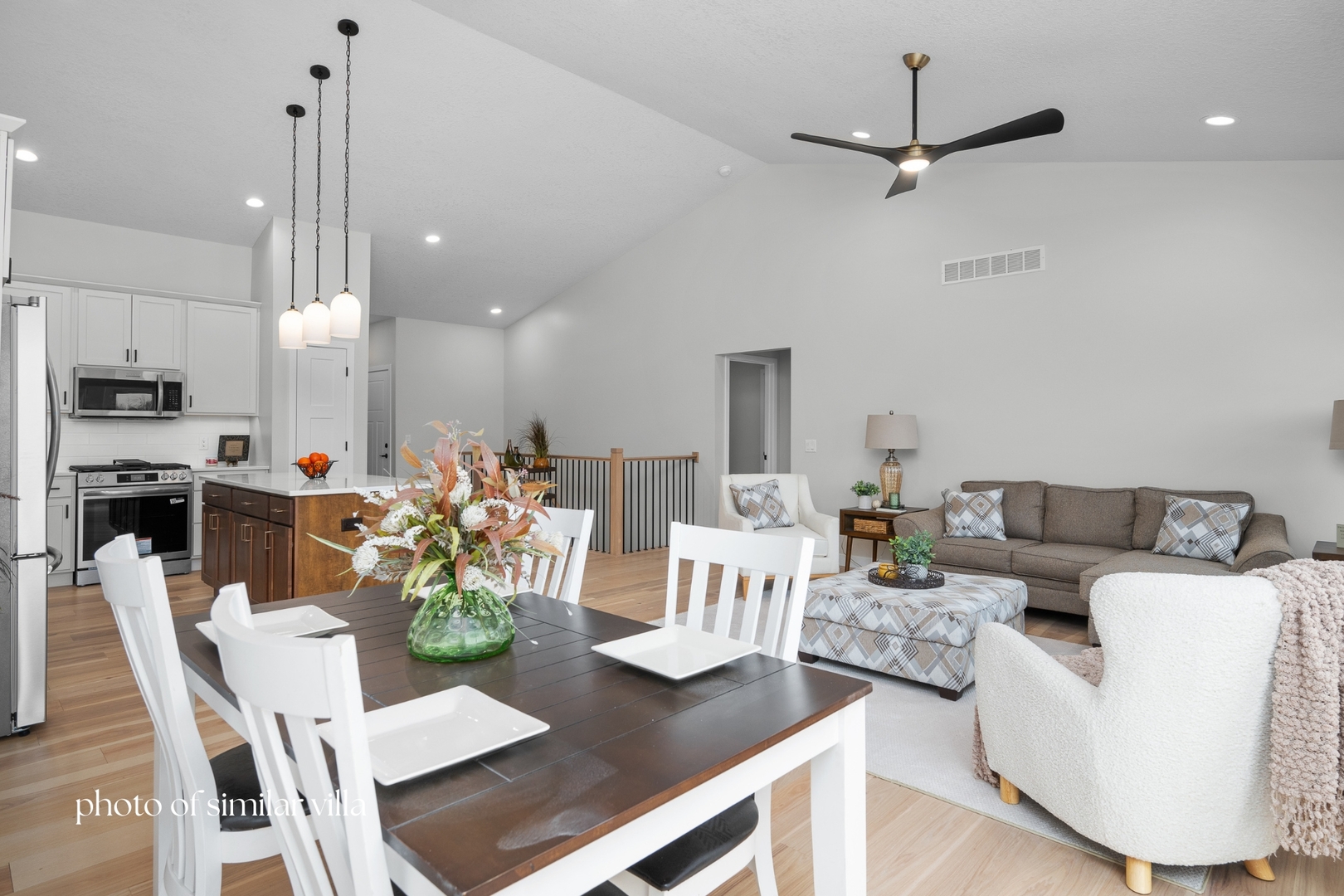 1867 Redbud Circle, Unit 101 Eldridge, IA 52748 - Photo 15 of 31 a living room with furniture kitchen view and a chandelier