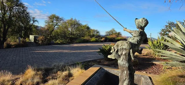 a living room with furniture a wooden floor and a floor to ceiling window