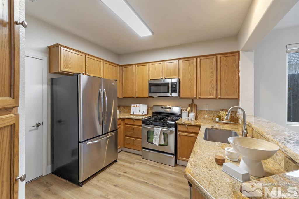 9725 Cattail Circle Reno, NV 89521 - Photo 7 of 38 a kitchen with a refrigerator sink and microwave