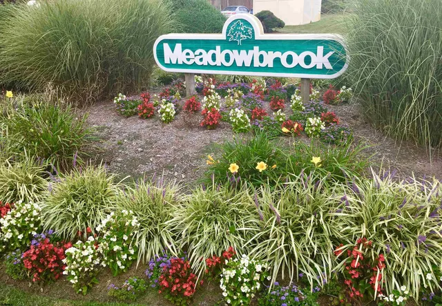 a street sign that is sitting in the middle of a field