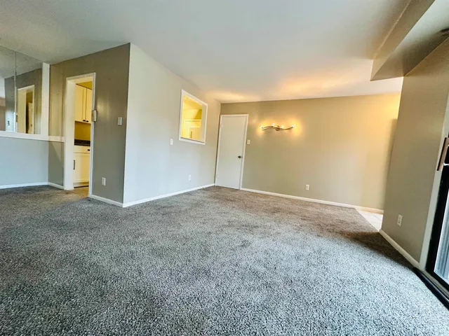 a view of a big room with windows and cabinet