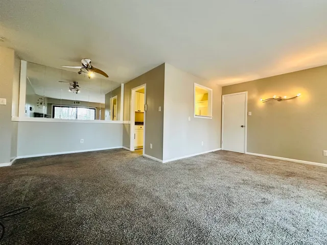 a kitchen with stainless steel appliances granite countertop a sink a stove and white cabinets