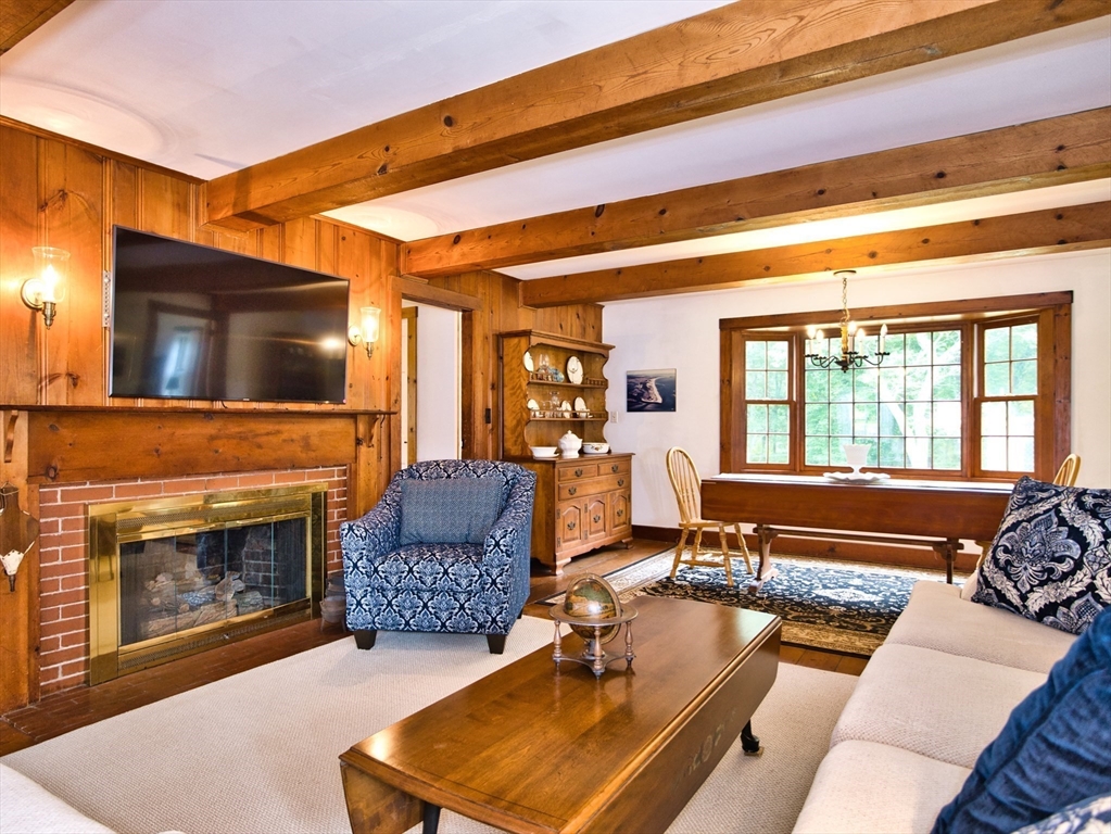 772 Gifford Road Westport, MA 02790 - Photo 13 of 37 a living room with furniture a flat screen tv and a fireplace