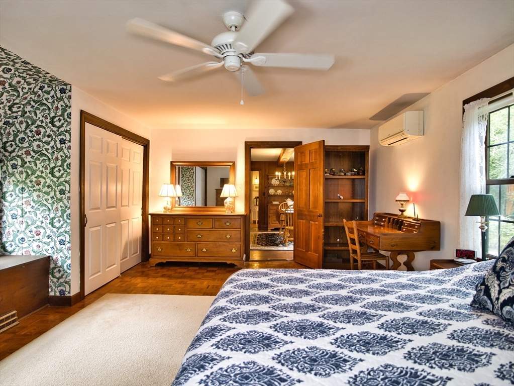 772 Gifford Road Westport, MA 02790 - Photo 17 of 37 a bedroom with a bed and wooden floor