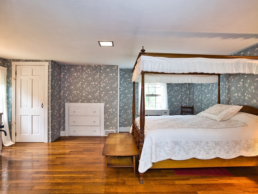 772 Gifford Road Westport, MA 02790 - Photo 24 of 37 a bedroom with a bed and wooden floor