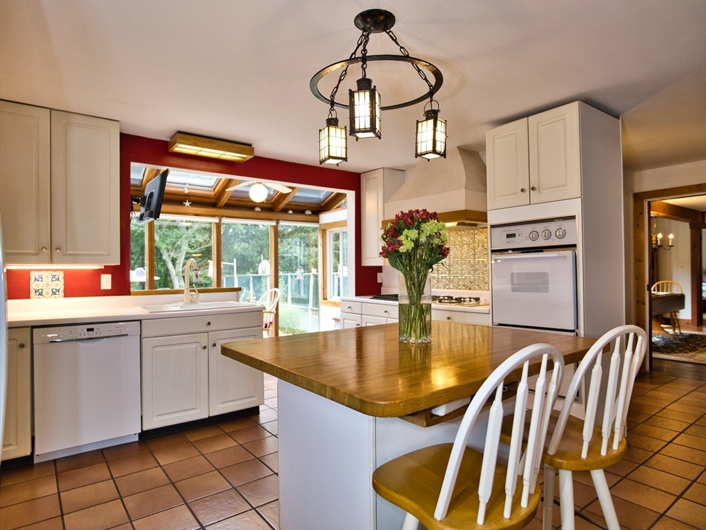 772 Gifford Road Westport, MA 02790 - Photo 6 of 37 a kitchen with stainless steel appliances granite countertop a sink dishwasher and a dining table with garden view