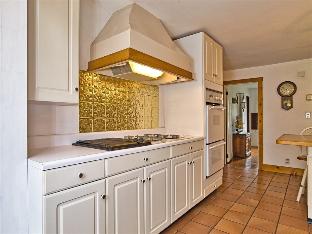 772 Gifford Road Westport, MA 02790 - Photo 7 of 37 a kitchen with a stove a sink and a refrigerator