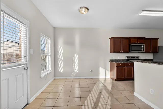 a kitchen with stainless steel appliances a stove a sink and a microwave