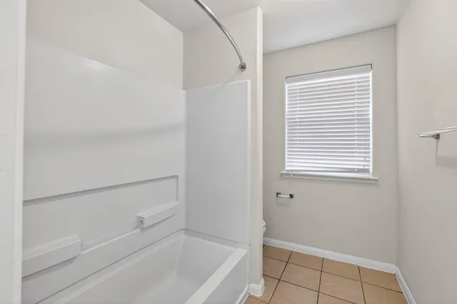 a bathroom with a bathtub and shower