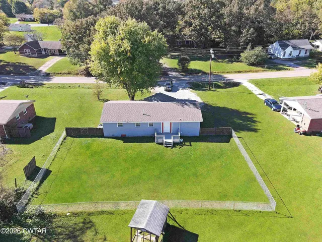 a view of a swimming pool with a yard