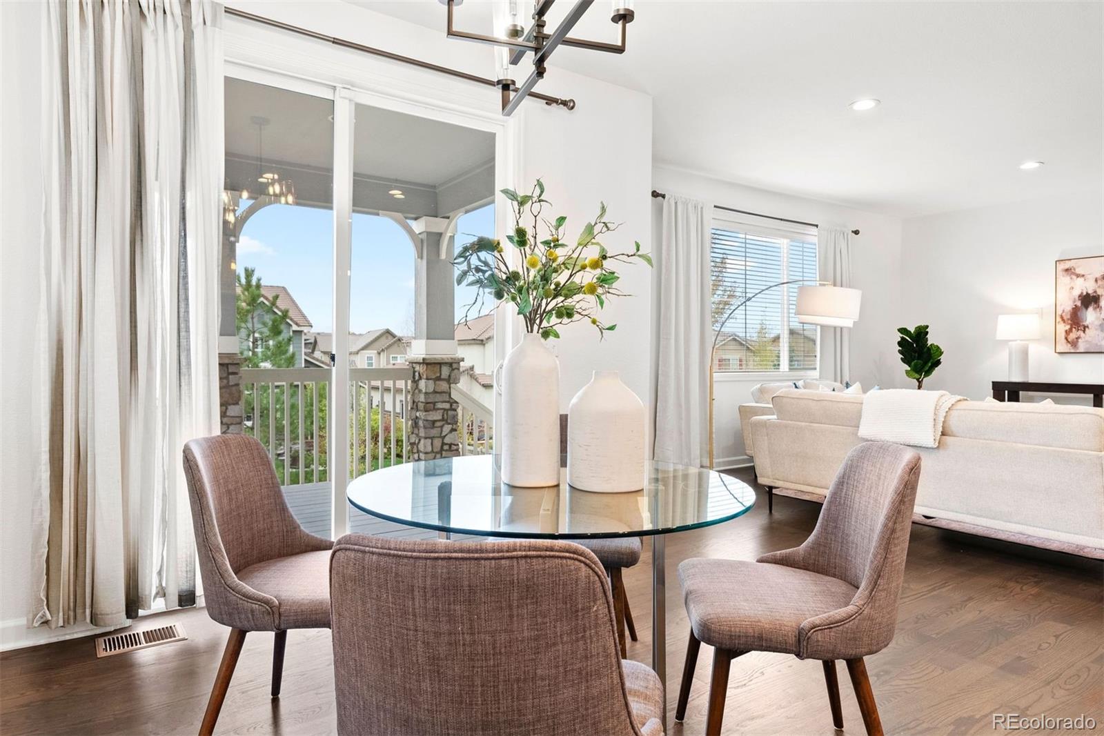 664 Tiger Lily Way Highlands Ranch, CO 80126 - Photo 13 of 47 a dining room with furniture and wooden floor