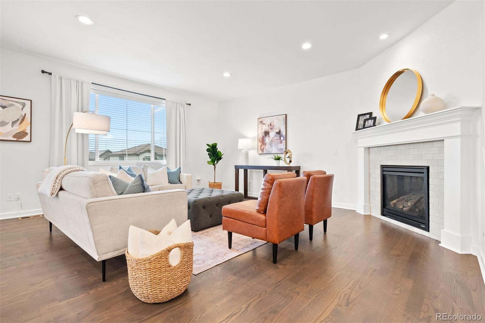 664 Tiger Lily Way Highlands Ranch, CO 80126 - Photo 14 of 47 a living room with furniture and a fireplace