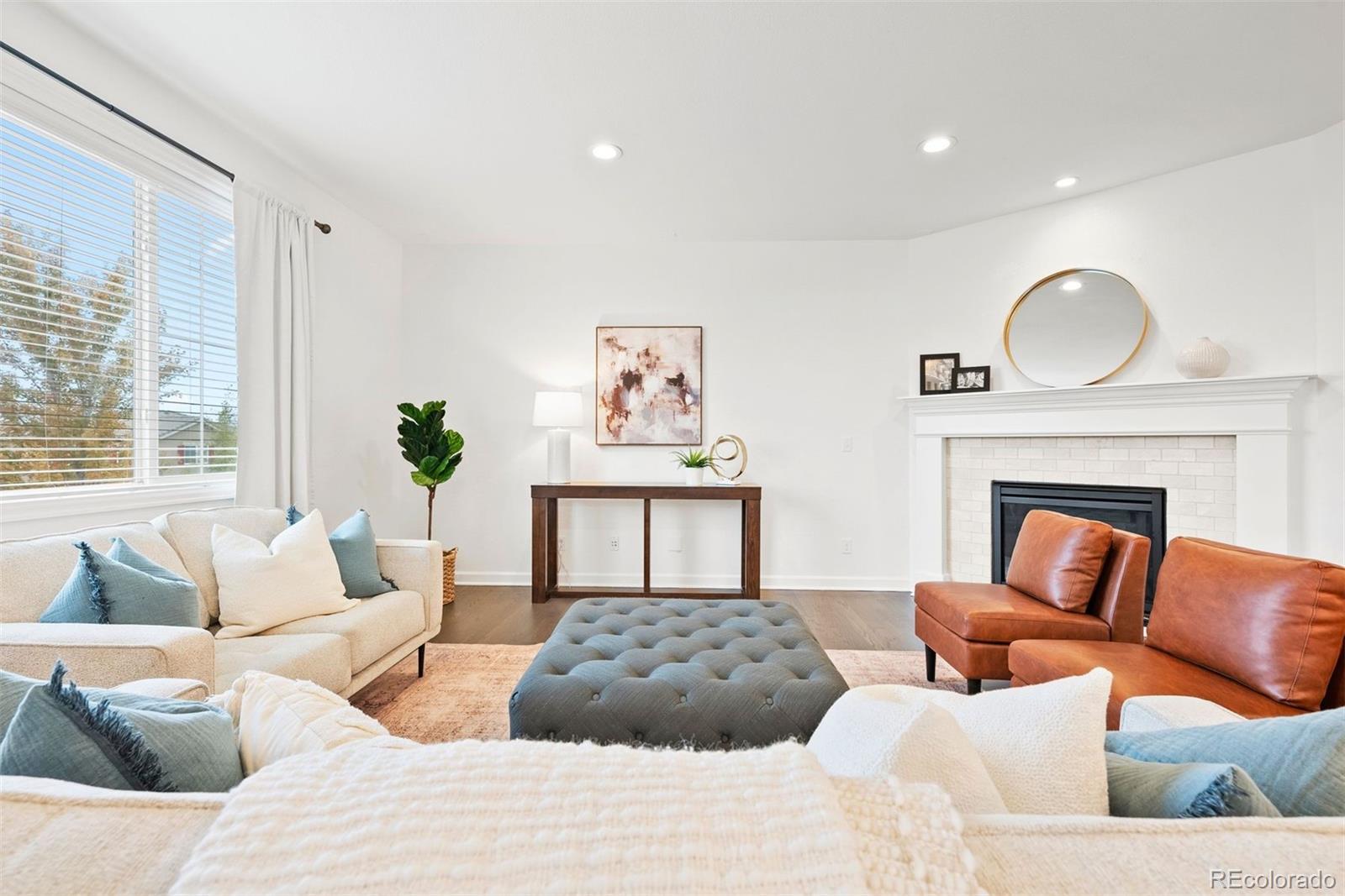 664 Tiger Lily Way Highlands Ranch, CO 80126 - Photo 16 of 47 a bedroom with furniture and a fireplace