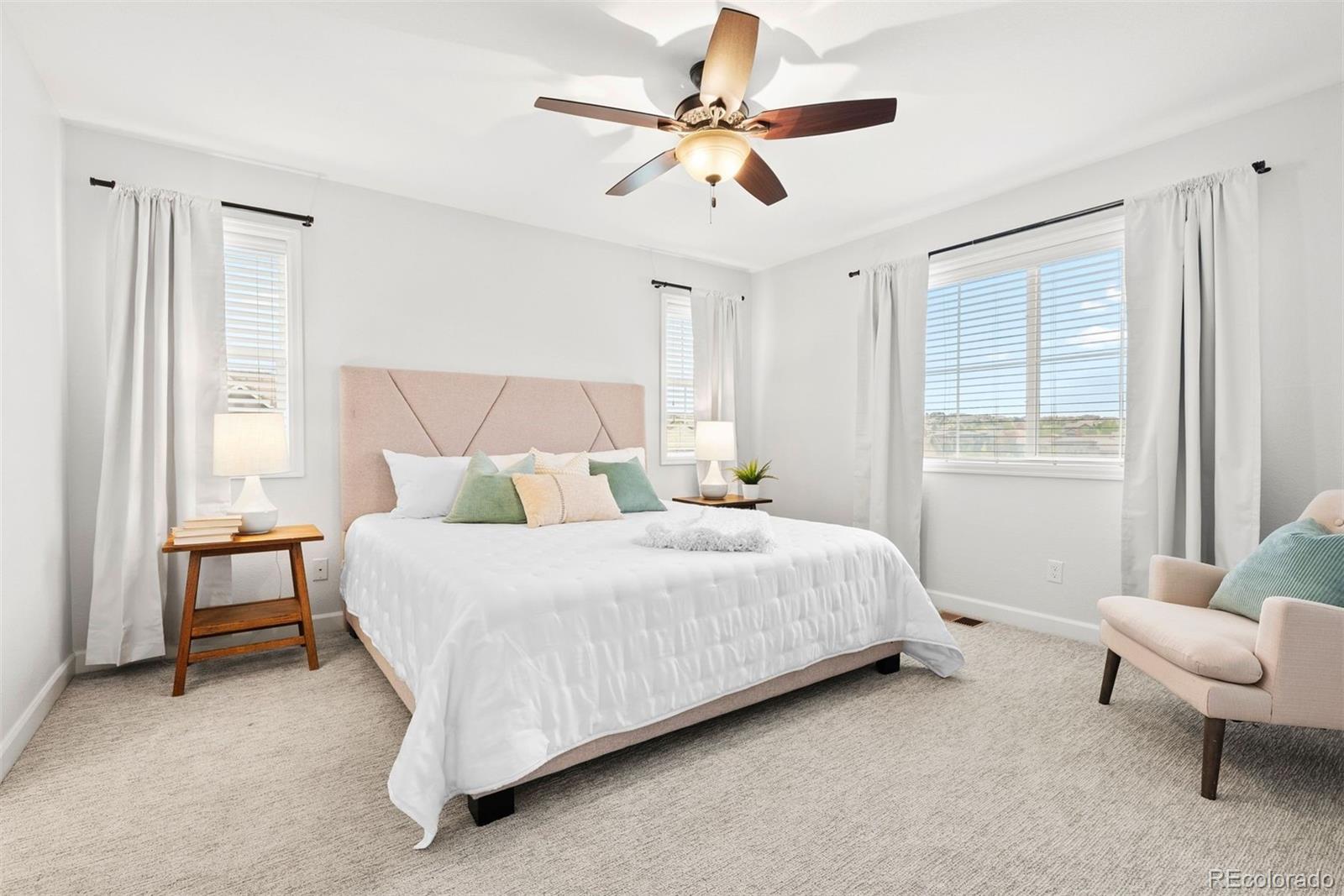 664 Tiger Lily Way Highlands Ranch, CO 80126 - Photo 21 of 47 a bedroom with a bed a chair and a large window
