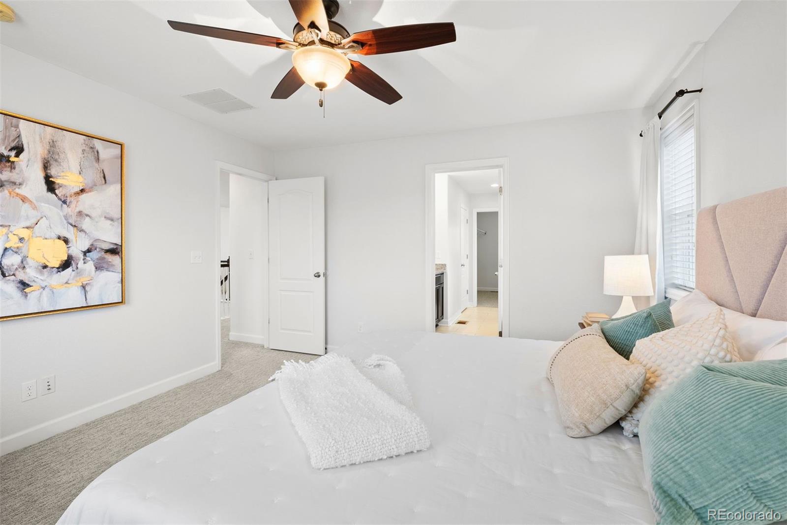 664 Tiger Lily Way Highlands Ranch, CO 80126 - Photo 23 of 47 a bedroom with a bed and a painting on the wall