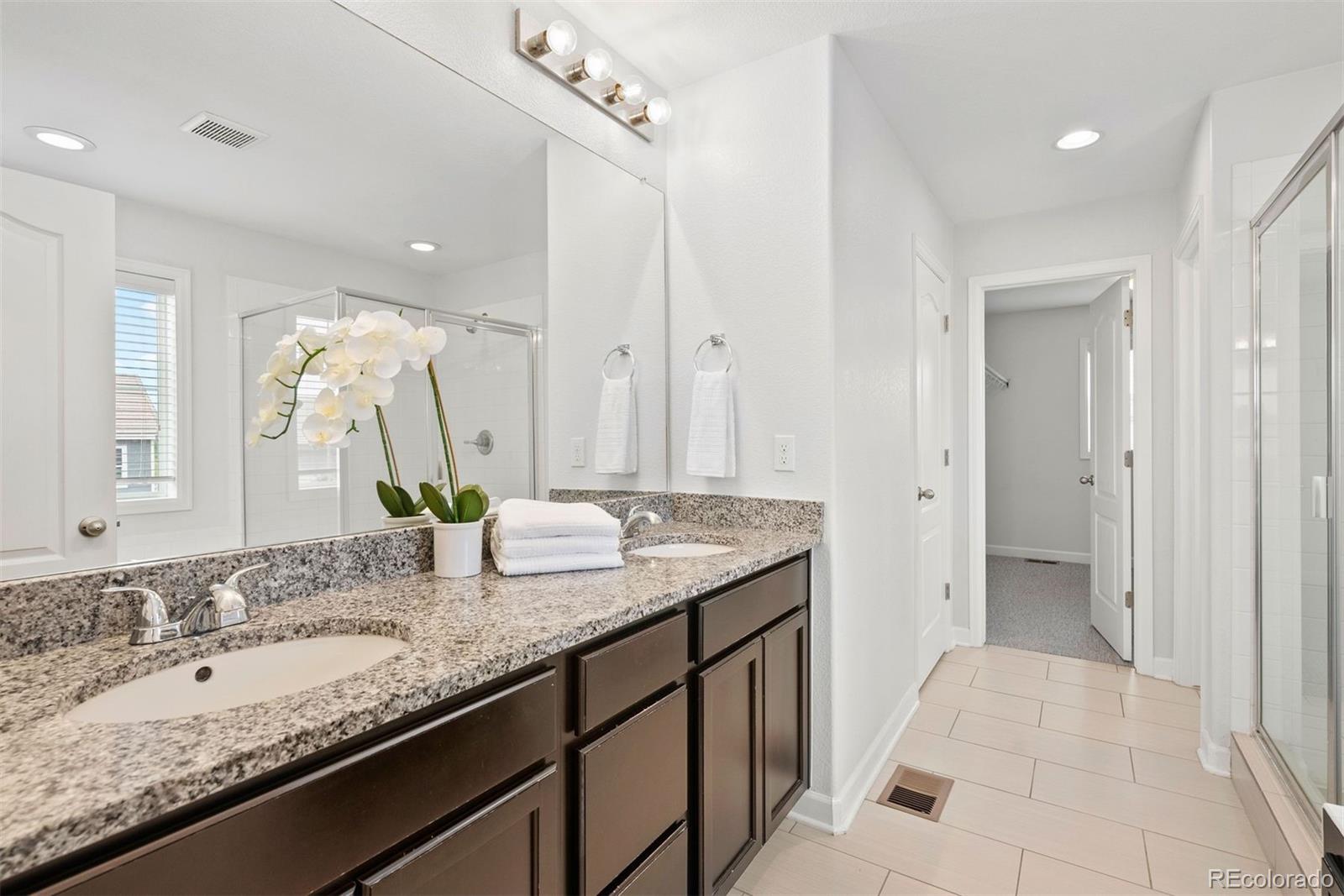 664 Tiger Lily Way Highlands Ranch, CO 80126 - Photo 24 of 47 a bathroom with a granite countertop sink and a mirror