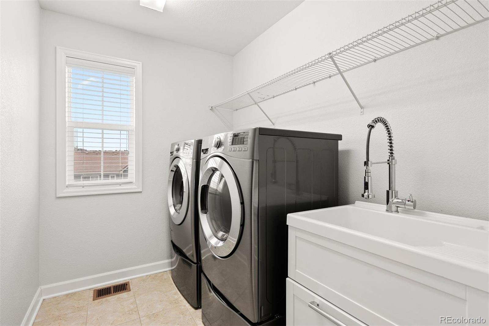 664 Tiger Lily Way Highlands Ranch, CO 80126 - Photo 30 of 47 a utility room with dryer and washer