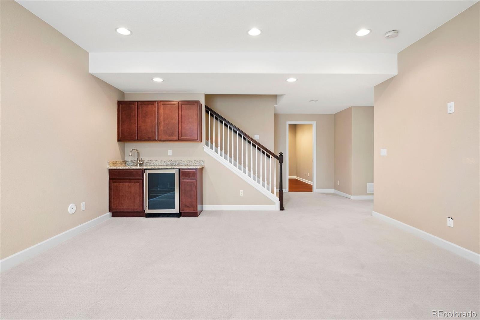 664 Tiger Lily Way Highlands Ranch, CO 80126 - Photo 32 of 47 a view of kitchen and kitchen with stainless steel appliances wooden floor
