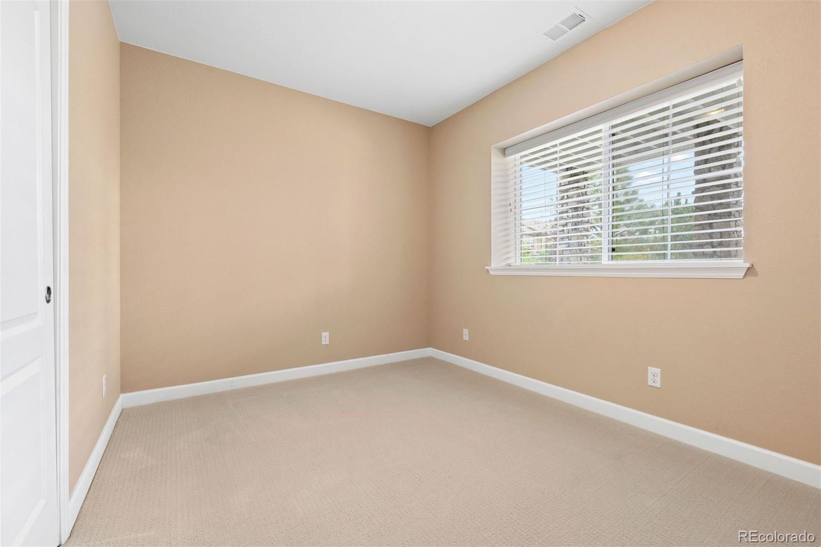 664 Tiger Lily Way Highlands Ranch, CO 80126 - Photo 34 of 47 an empty room with a window