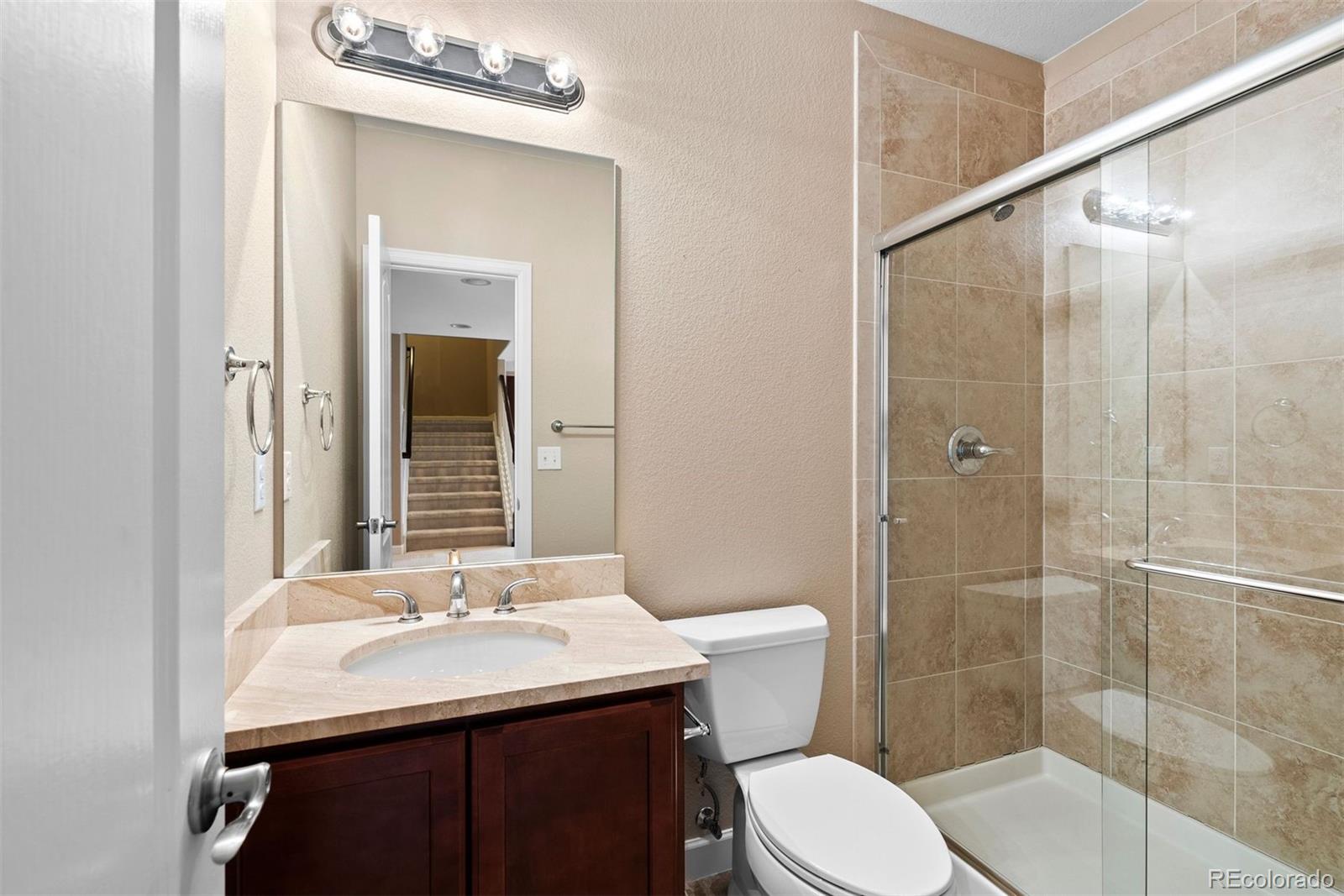 664 Tiger Lily Way Highlands Ranch, CO 80126 - Photo 36 of 47 a bathroom with a sink toilet and shower