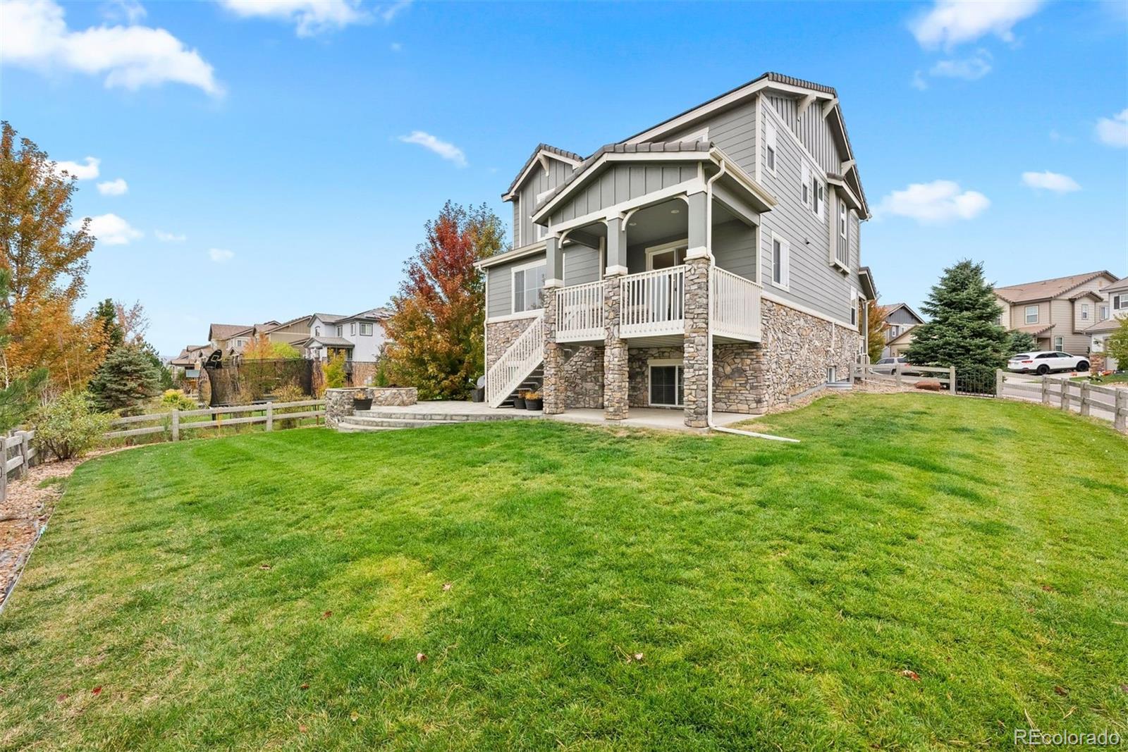 664 Tiger Lily Way Highlands Ranch, CO 80126 - Photo 38 of 47 a view of a big house with a yard