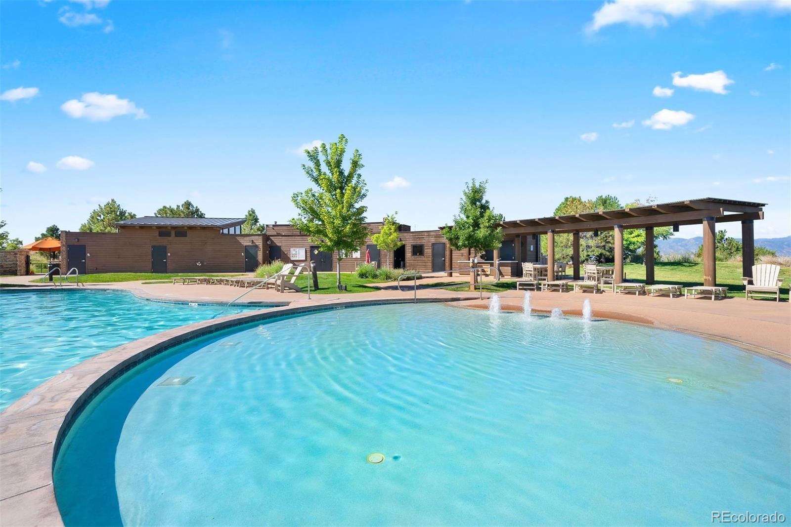 664 Tiger Lily Way Highlands Ranch, CO 80126 - Photo 41 of 47 a swimming pool with outdoor seating and yard