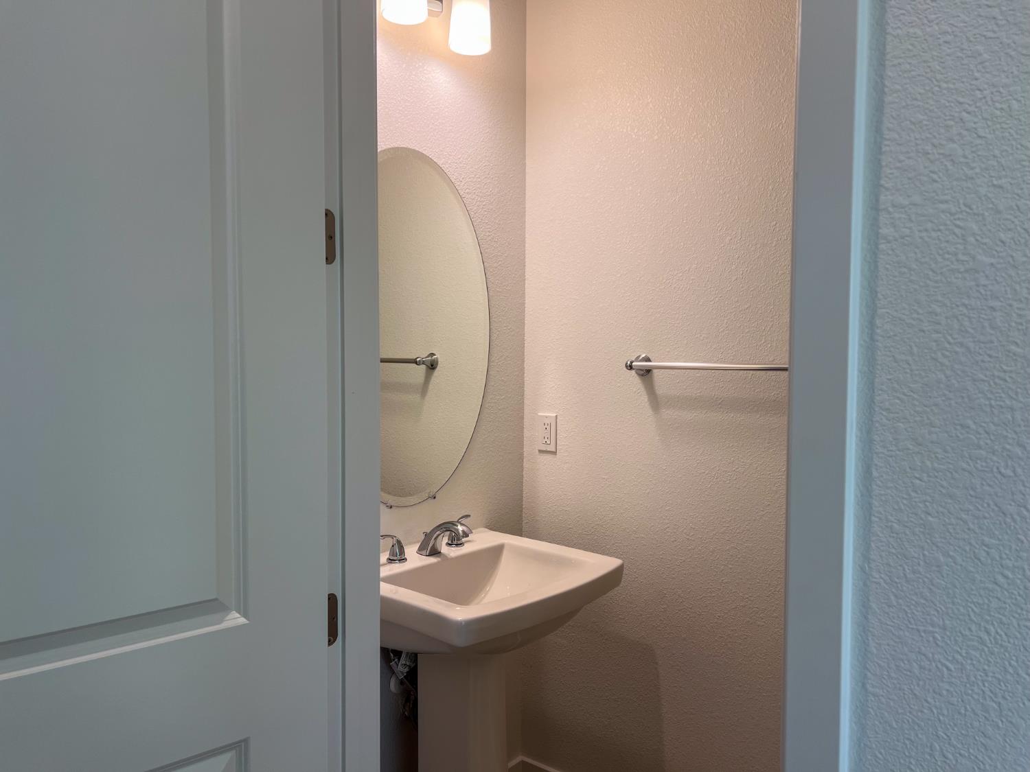 3368 Houser Court Davis, CA 95616 - Photo 12 of 19 a bathroom with a sink and mirror with toilet