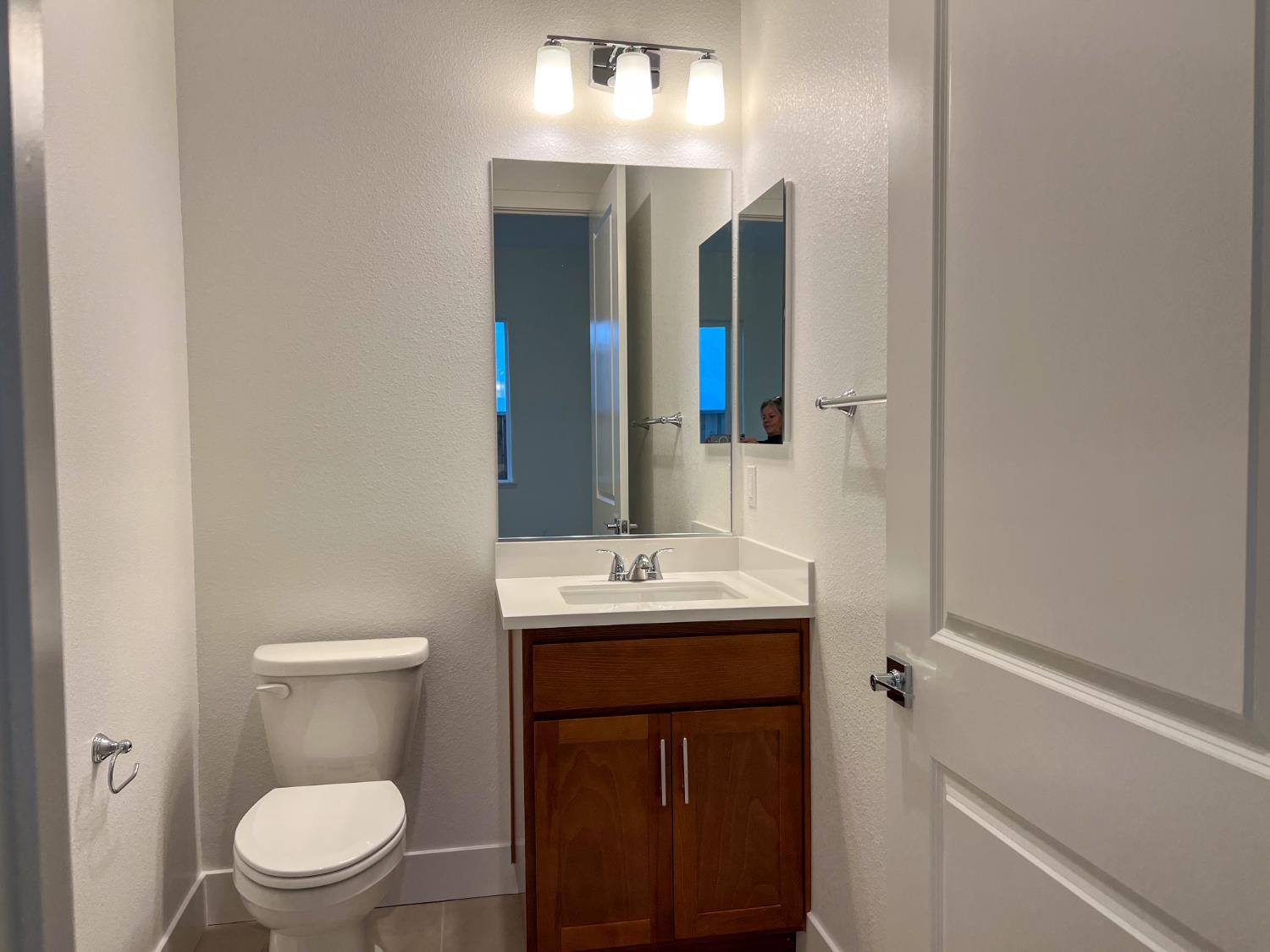 3368 Houser Court Davis, CA 95616 - Photo 15 of 19 a bathroom with a toilet sink and mirror
