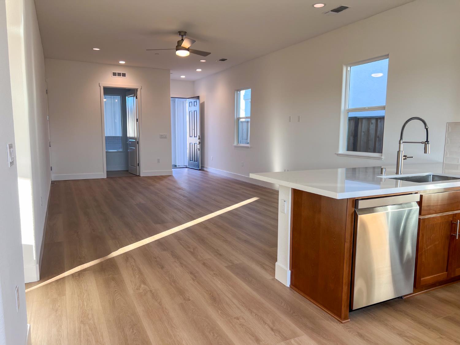 3368 Houser Court Davis, CA 95616 - Photo 5 of 19 a view of kitchen with kitchen island a sink wooden floor and window