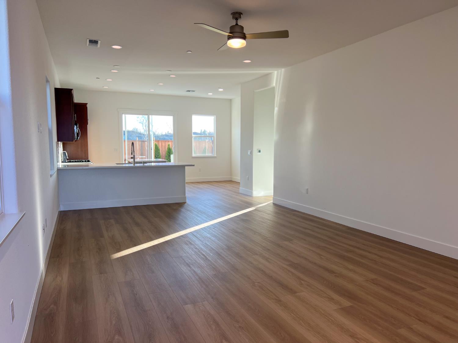 3368 Houser Court Davis, CA 95616 - Photo 7 of 19 wooden floor in an empty room with a window