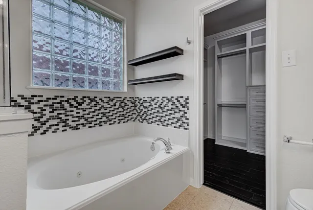 a bathroom with a bathtub and a shower