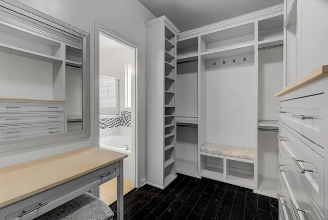 a view of walk in closet with empty racks