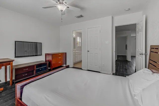 a bedroom with a bed and a chandelier