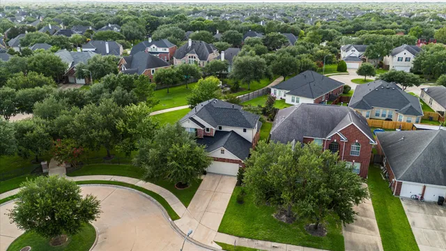 an aerial view of residential houses with outdoor space and street view
