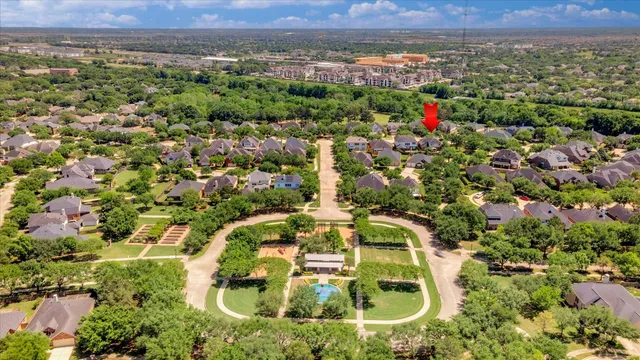 an aerial view of residential house with outdoor space and trees