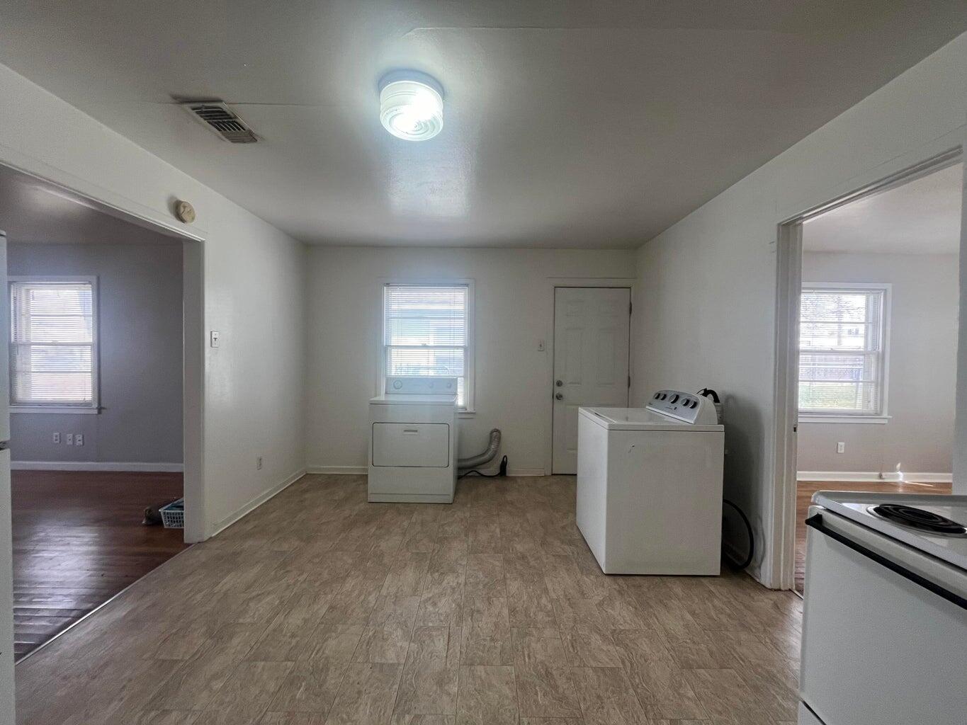 3113 33rd Street, Unit A Lubbock, TX 79410 - Photo 5 of 10 an empty room with a fireplace and windows