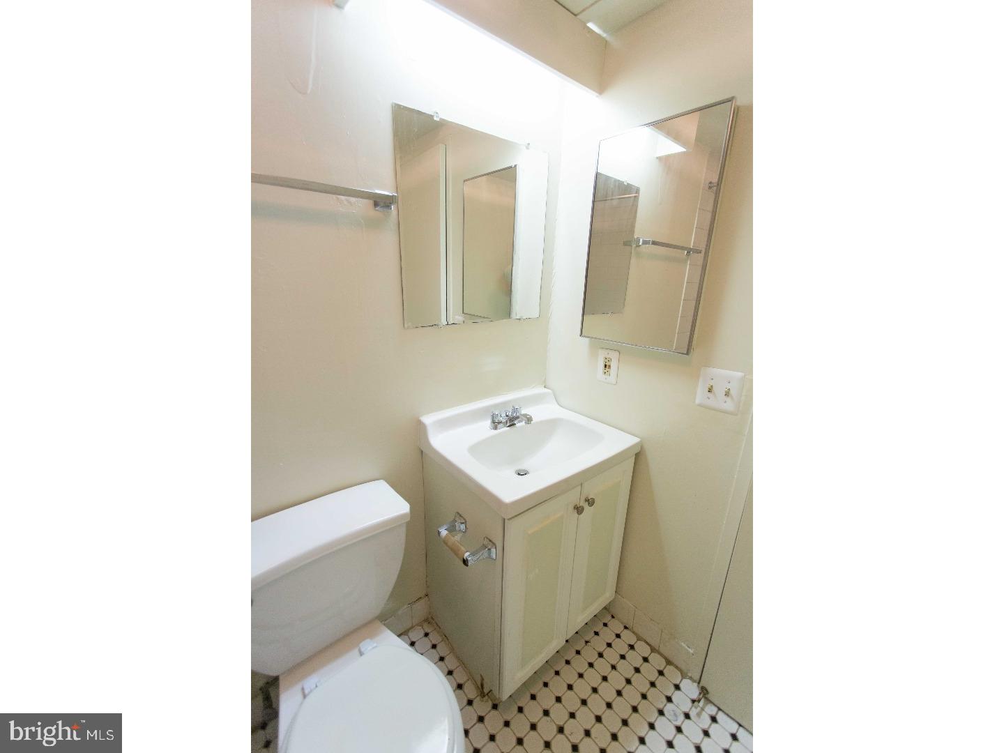 130 Arch Street, Unit 104 Philadelphia, PA 19106 - Photo 21 of 22 a bathroom with a sink toilet and a mirror