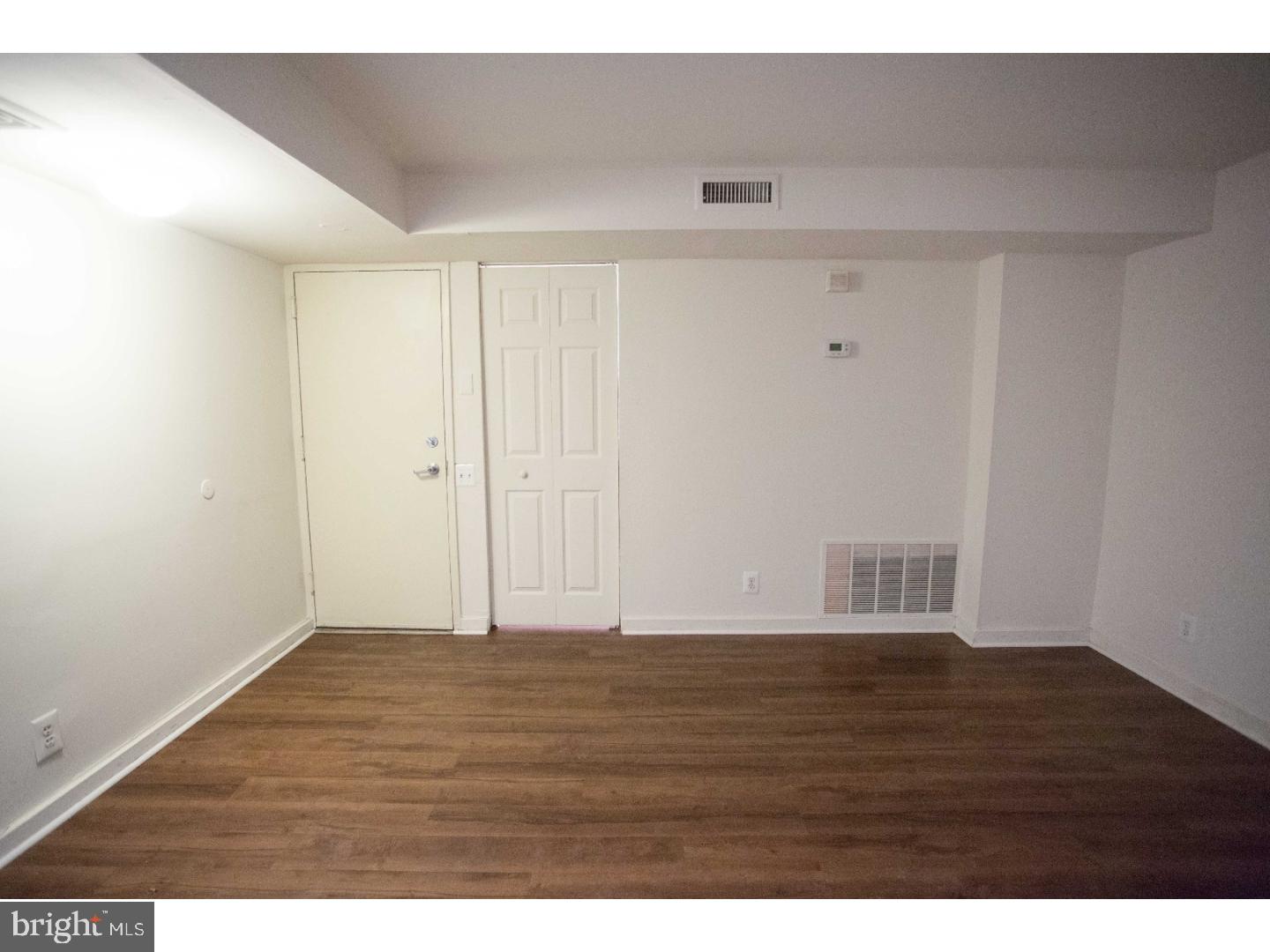 130 Arch Street, Unit 104 Philadelphia, PA 19106 - Photo 7 of 22 a view of an empty room with wooden floor