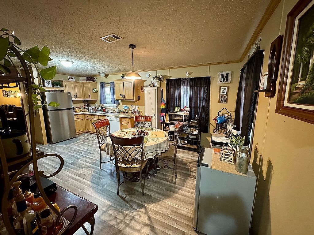 3351 East State Line Road Union City, TN 38261 - Photo 4 of 36 a view of a dining room with furniture a rug and wooden floor
