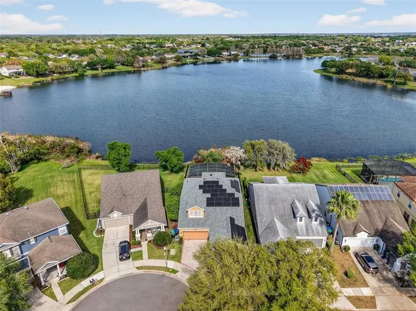an aerial view of a house with a lake view
