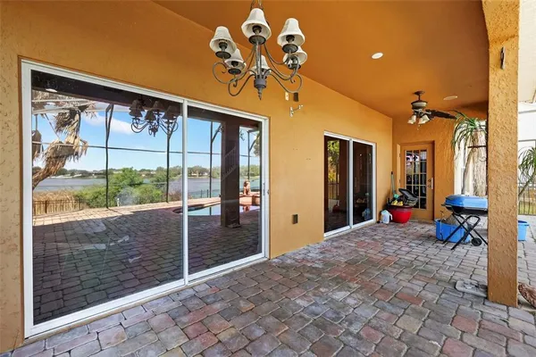 a view of a porch with a table and chairs
