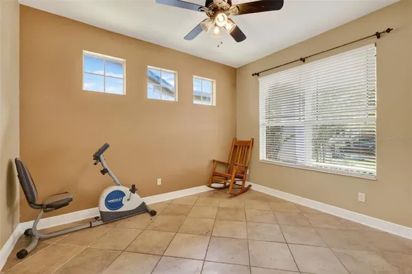 a room with gym equipment and windows