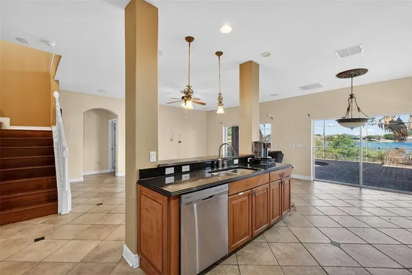 a kitchen with stainless steel appliances granite countertop a stove a sink and a wooden floors