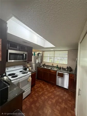 a kitchen with stainless steel appliances granite countertop a stove and a refrigerator