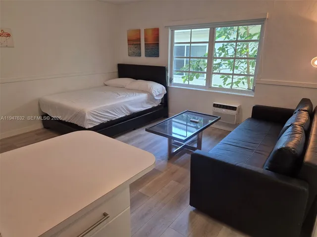 a bedroom with furniture and a window