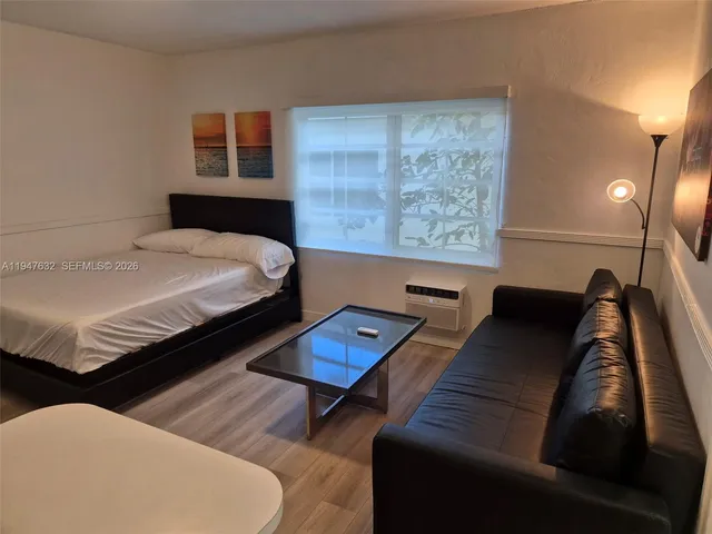 a bedroom with bed and a night stand