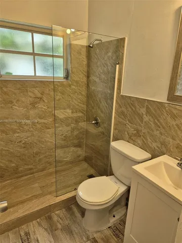 a bathroom with a toilet and a shower